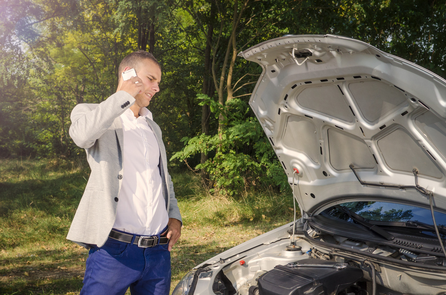 man-standing-by-open-hood-making-phone-call-trying-fix-vehicle (1)