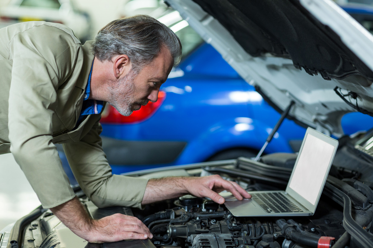 mechanic-using-laptop-while-servicing-car-engine (2)